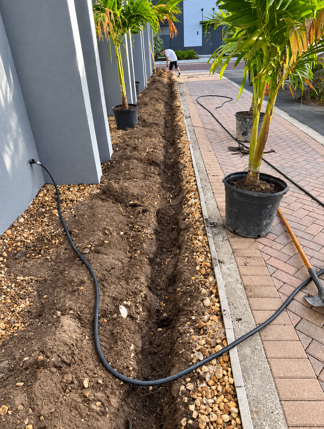 Irrigation trench installed neatly beside a commercial walkway